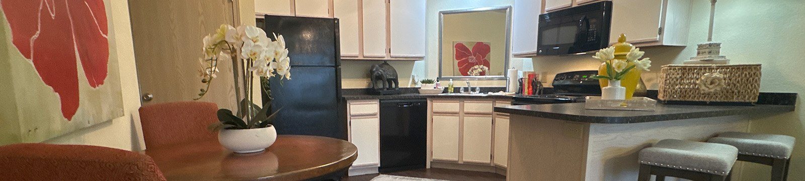 A kitchen with a table and chairs.